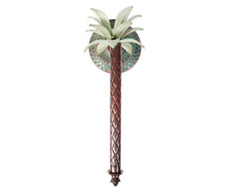 A retro vintage 1960's style candle stick wall sconce in the form of a palm tree having&nbsp;a patina green finish to the pal