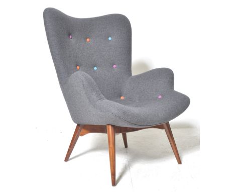 A contemporary Poet style easy / lounge chair / armchair having shaped back and armrests&nbsp; upholstered in a dark grey and