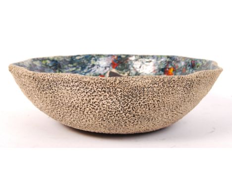 A 20th century studio art pottery large bowl with heavily textured exterior and mottled green , blue and red glazes with hunt