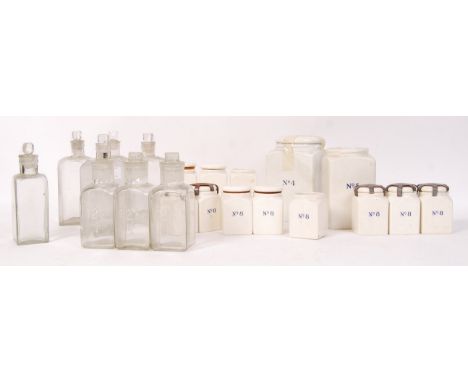 A collection of assorted early 20th century atique vintage military porcelain and glass apothecary chemist medicine jars. Por