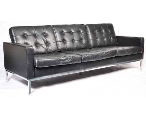 After Florence Knoll - A contemporary large three seat sofa settee comprising of black button backed leather cushions and uph