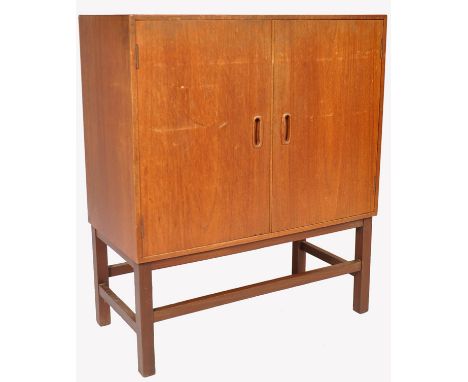 A 1960's retro vintage teak wood vinyl record cabinet having double doors revealing a pigeon hole divider interior with large