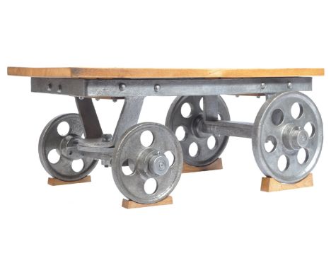 An early 20th century / late 19th century industrial vintage foundry cart having cast iron and forged components with an oak 