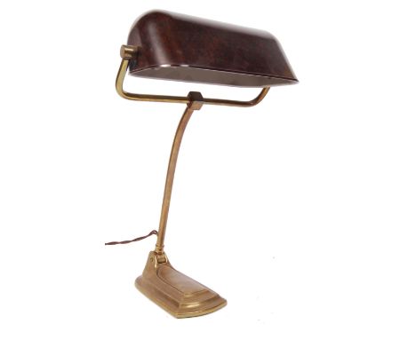 A stunning Art Deco 1920's brass and Bakelite bankers lamp having a weight stepped foot and pivoted sweeping arm supporting a
