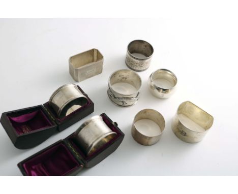 NAPKIN RINGS:- A napkin ring with bead borders by W.H. Haseler, Birmingham 1921 (fitted box), a Victorian engine-turned napki