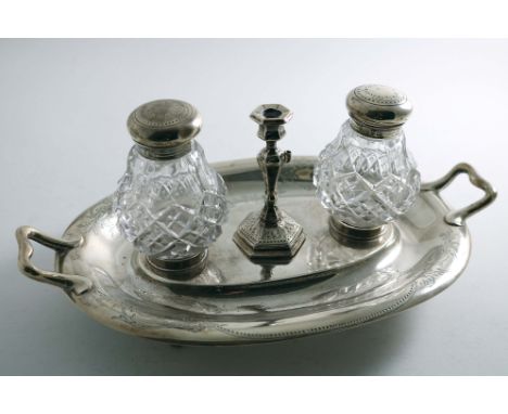 A VICTORIAN OVAL INKSTAND with twin handles and engraved decoration, fitted with two mounted cut-glass bottles and a central 