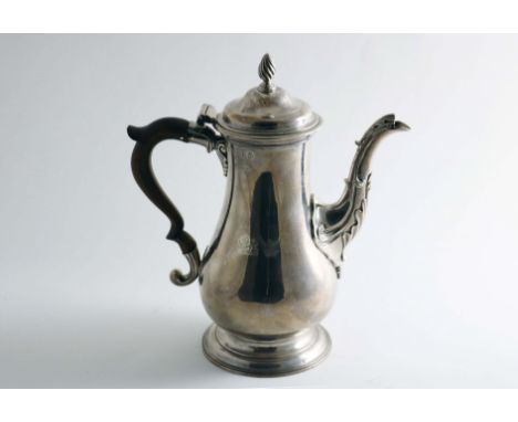 AN EARLY GEORGE III COFFEE POT of plain baluster form with a spreading circular foot, decorative spout and domed cover with a