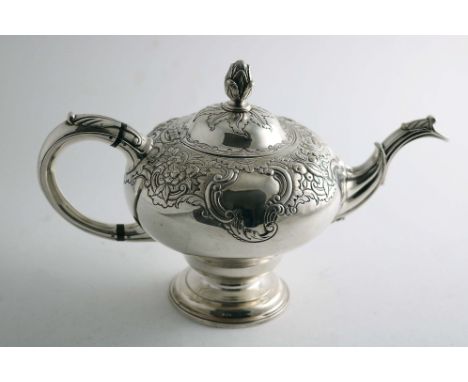 A LATE GEORGE II SCOTTISH TEA POT of inverted baluster form with a chased upper body, circular foot and a domed cover with a 