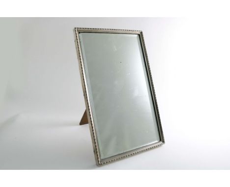 AN EARLY 20TH CENTURY RECTANGULAR MIRROR FRAME with a bobbin border and a wooden easel back, by Walker &amp; Hall, Sheffield 