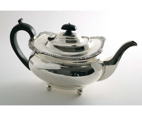 AN EDWARDIAN TEA POT of rounded oblong form on ball feet with a gadroon &amp; foliate shell border, by R. Pringle, London 190