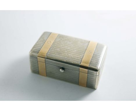 AN EARLY 20TH CENTURY GENTLEMAN'S TOILET BOX of rounded oblong form with a button thumbpress, decorated with engine-turning a