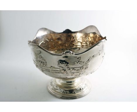 AN EDWARDIAN ROSE BOWL with a wavy scroll rim and repousse Art Nouveau floral decoration around the sides and two vacant cart