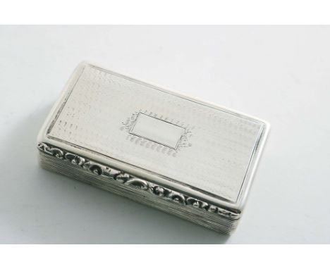 A WILLIAM IV RECTANGULAR SNUFF BOX with reeded sides, engine-turned cover &amp; base and a raised foliate thumbpiece, gilt in