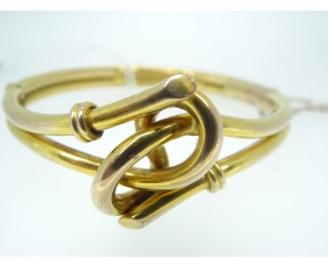 9CT YELLOW GOLD BANGLE with knot design to the centre, 13gmsYes there is some damage, there is one dent and some cracks aroun