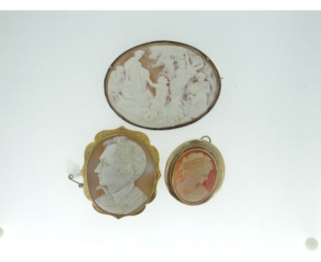 THREE ANTIQUE CAMEO BROOCHES to include an extensively carved mythological scene oval brooch with numerous figures in a white