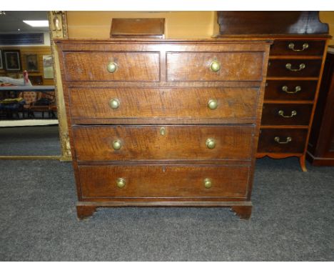 19TH CENTURY OAK CHEST OF THREE LONG AND TWO SHORT DRAWERS on carved bracket feet and with brass knobs, 104cms wide