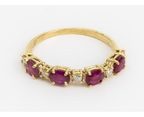 A RUBY AND DIAMOND RING
Featuring oval cut rubies mounted in a yellow gold setting marked '750' to the shank, accented with r