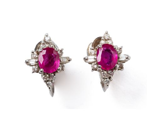 A PAIR OF RUBY AND DIAMOND SCREWBACK EARRINGS
Featuring two oval cut rubies weighing approximately 0.82 cts total, mounted on