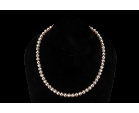 AN AKOYA CULTURED PEARL SINGLE STRAND NECKLACE
The Akoya cultured pearls measuring approximately 6.5 to 7mm, marked 'Silver' 