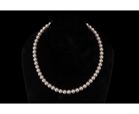 AN AKOYA CULTURED PEARL SINGLE STRAND NECKLACE The Akoya cultured pearls measuring approximately 7.5 to 8mm, with a gold plat