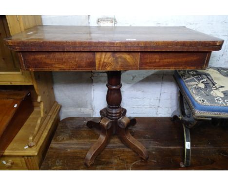 A Regency mahogany fold over card table, on a sabre leg base 