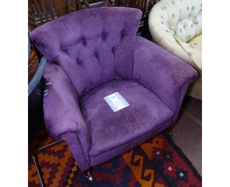 An Edwardian button-back upholstered armchair 