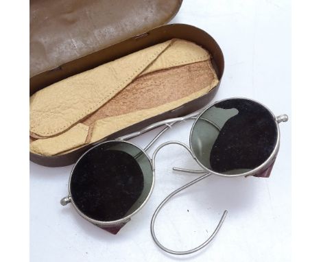 A pair of military tinted spectacles in metal case, by M Wiseman &amp; Co 