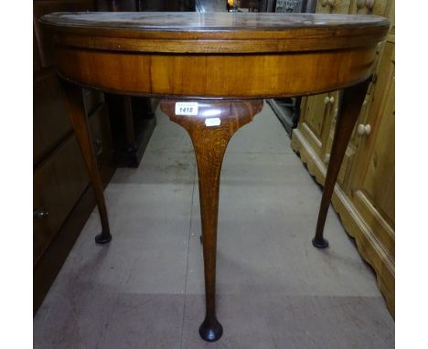 A 1930s cross-banded walnut fold over card table, raised on cabriole legs, W80cm 