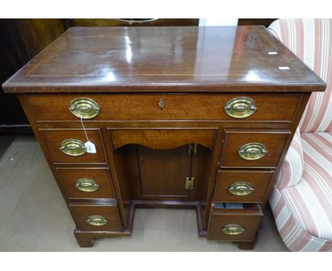 A 19th century Queen Anne style mahogany knee-hole desk, with satinwood stringing, and fitted with 7 drawers, on bracket feet
