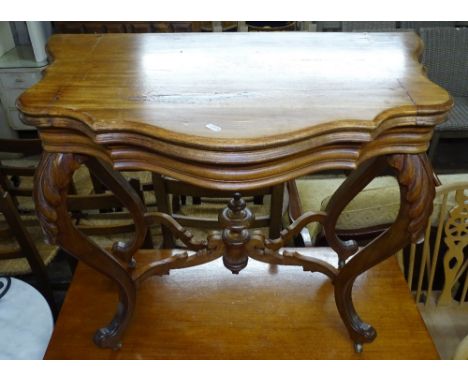 A French oak serpentine-front fold over card table, and a mahogany serpentine-front side table on turned legs 