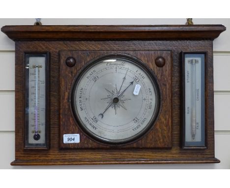 An oak aneroid barometer with thermometer 