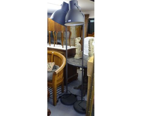 A contemporary standard lamp with large metal industrial style shade 