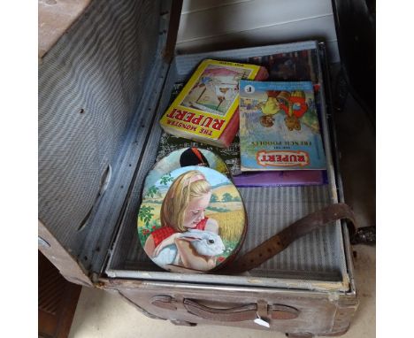 A trunk containing Rupert annuals, tins etc 
