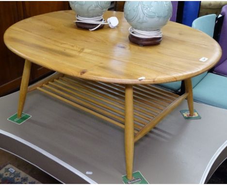 An Ercol oval elm 454 2-tier coffee table, on turned legs, with blue label, L100cm 