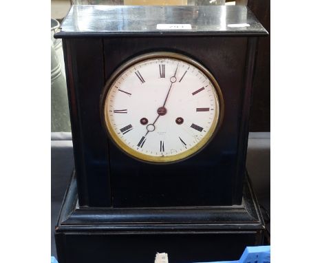 A rhinoceros, a Ricard bottle, and a 2-train mantel clock 