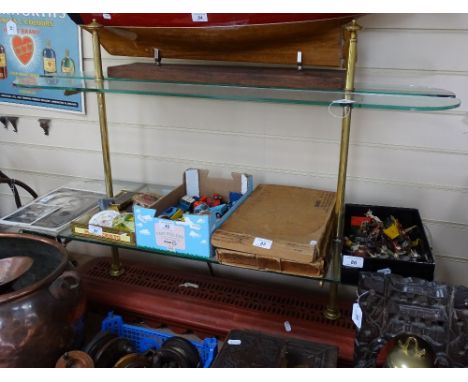 A freestanding shelf unit with brass columns, glass shelves, and metal base, length 40" 