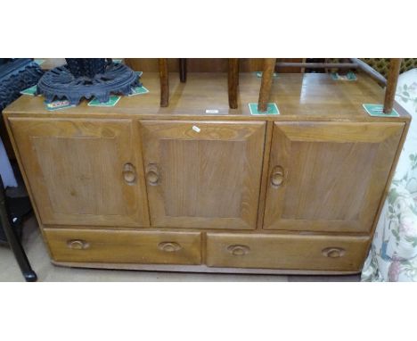 An Ercol elm Windsor sideboard, with fitted cupboards and drawers, L130cm 