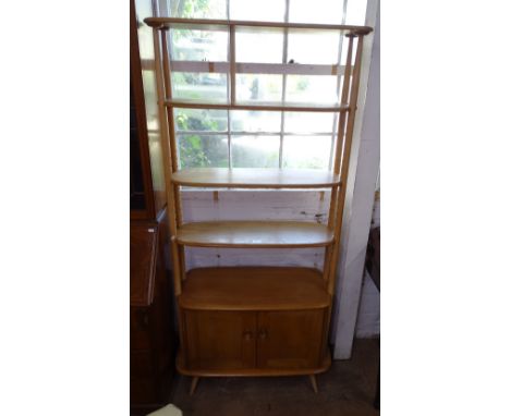 An Ercol elm and beech "giraffe" room divider, with adjustable shelves and cupboards under, H191cm, W85cm 