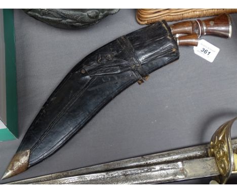 A kukri knife in leather scabbard 