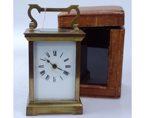 A brass carriage clock with leather carrying case 