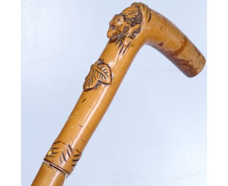 A Victorian sword stick with a carved wood handle 