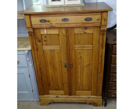 A French pitch pine cabinet, with frieze drawer above 2 panelled doors on bracket feet, W98cm, H145cm 
