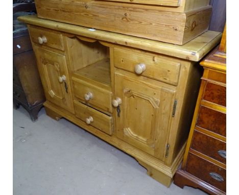 A polished pine dresser base, with fitted drawers and cupboards on bracket feet, W125cm 