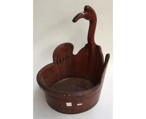 A carved wooden planter in the form of a bird 