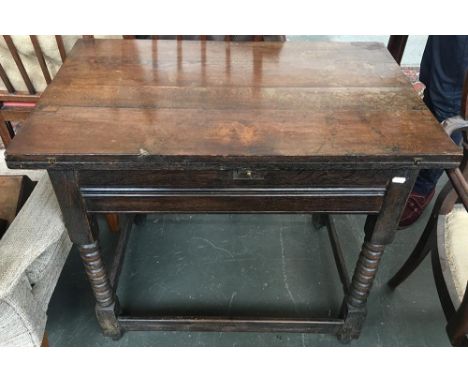 An oak refectory style table, fold over extending top, on bobbin turned legs joined by square stretchers, 85x53x70cmH 