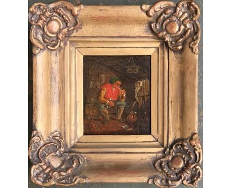 19th century Continental School, peasant man smoking a pipe in house, oil on board in gilt frame, label en verso reads 'Rober