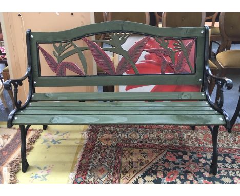 A slatted garden bench with a foliage design back and cast iron ends, 125cmW 