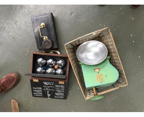 A mixed lot to include a money box with key, vintage Kit Way scale with weight, together with a box of lawn bowls 