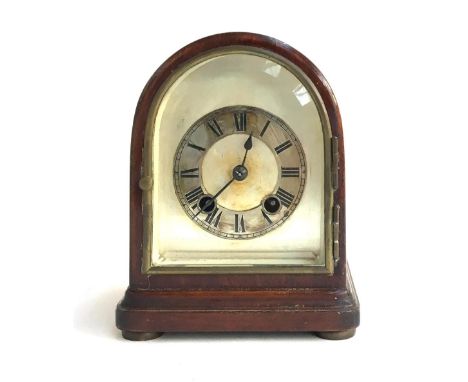 A mahogany dome cased mantel clock, silvered dial with Roman numerals, behind bevelled glass, 18cmH 