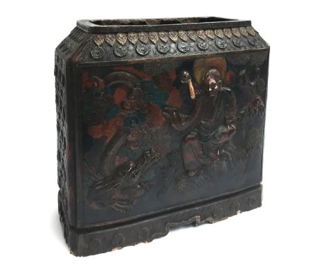 A 19th century Japanese lacquered carved stick stand, depicting figures beside a lion and dragon 